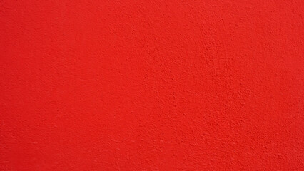 Textured wall in vibrant saturated red color.