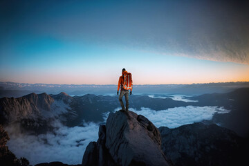 Success concept, with mountain climber standing on top of mountain at sunset, Generative AI illustration