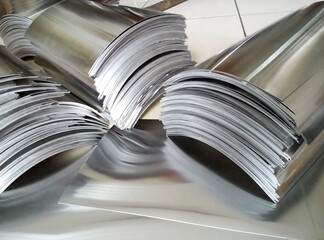 pile of industrial aluminum metal on the floor of a room. small rectangular pieces