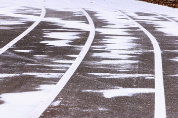 Treadmill, paved, with markings for runner athletes. In winter in snowy weathe