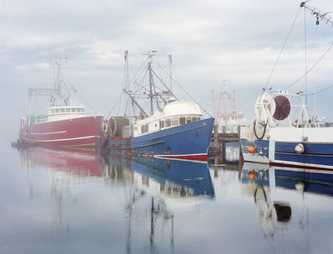Trawlers tied to Wrights Wharf on a foggy morning in Portland, ME