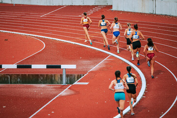 Female athletes pushing their limits in long distance race. Perfect for sports and fitness...