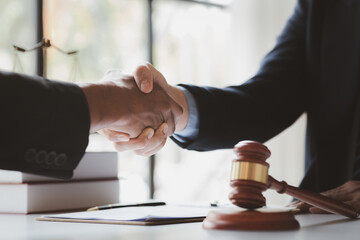 Lawyers shake hands with clients who come to testify in the case of embezzlement from business partners who jointly invest in the business. The concept of hiring a lawyer for legal proceedings.