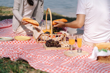 In love couple enjoying picnic time in park outdoors Picnic. happy couple relaxing together with picnic Basket