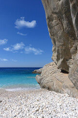 White rocky bay forming natural shadow and beautiful pebble beach in exotic Caribbean island