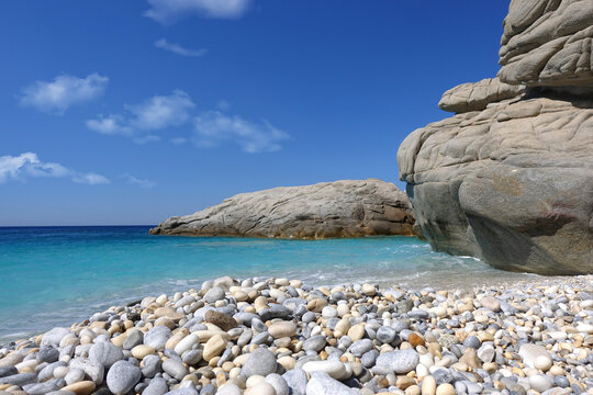 Beautiful paradise turquoise pebble beach of Seychelles in island of Ikaria, North Aegean sea, Greece