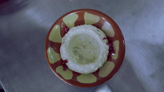 Adding Tomato, Cumin, Mint And Pouring Organic Oil Over Hummus Eggplant Dish 