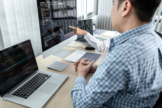 Team of two professional programmers working on website projects in software development on the desktop computer and making coding and typing data code password security in office