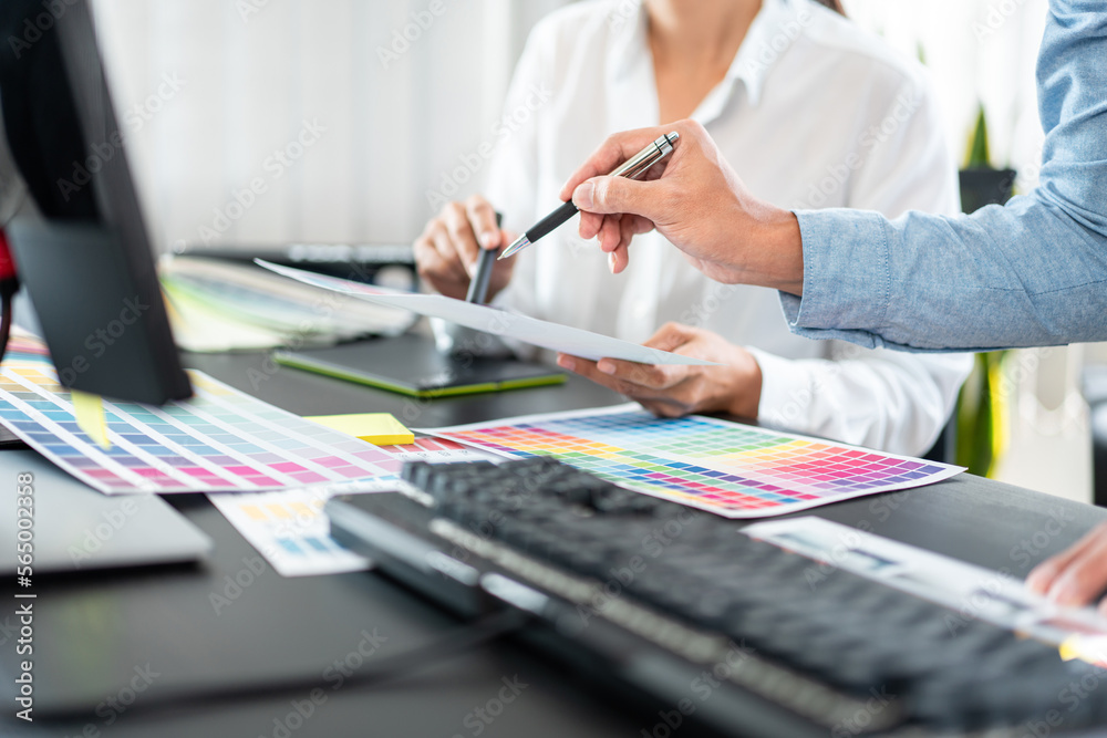Poster two creative graphic designer team working on color selection and drawing on graphic tablet, color s