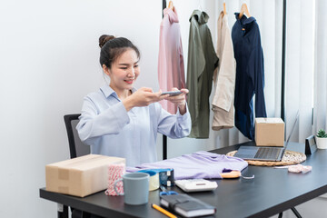 Women fashion designer stylist sell product and recieve order from customer and prepare packing clothes into boxes for sending delivery to client at home
