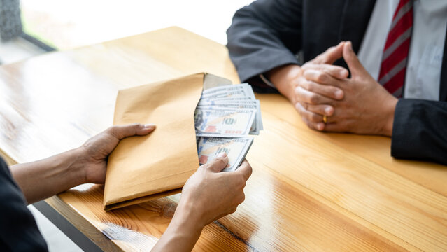 Bribe employer is offer terms to the businessman for signing on contract while making corruption about buy land and real estate, Bribery and corruption concept