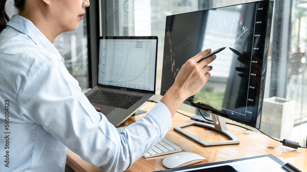 Poster businesswoman investor having planning and analyzing graph data with display screen the data present