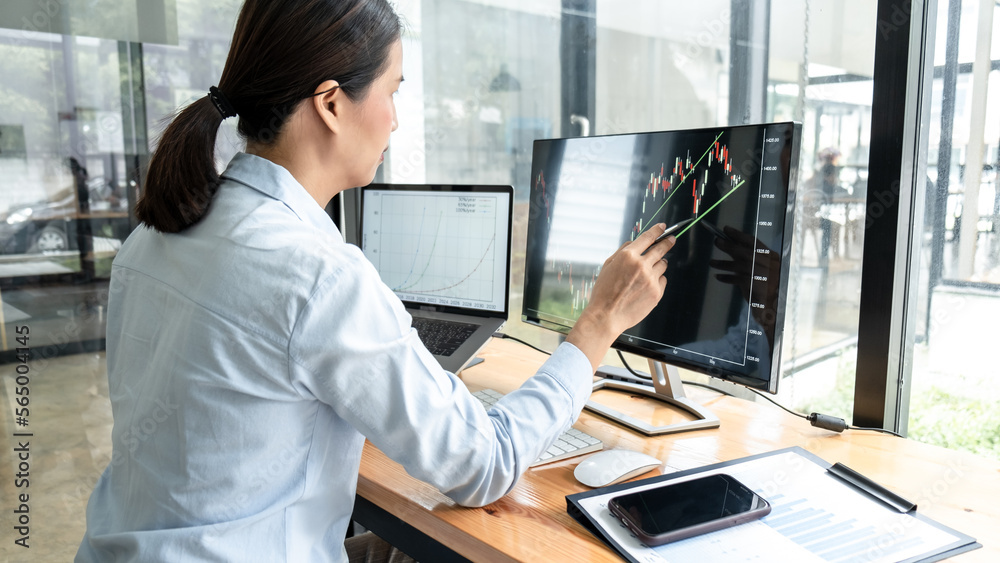 Poster businesswoman investor having planning a new project and analyzing graph data with display screen th
