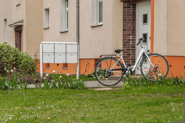 Bike and the post boxes at the entrance to a building in Germany.
