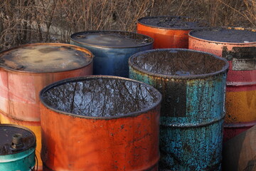 close up of used oil drum. old and rusty and in various colors