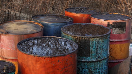 close up of used oil drum. old and rusty and in various colors