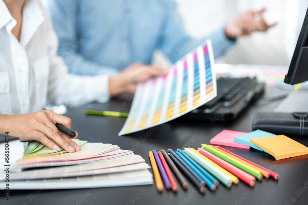 Poster Team of creative graphic designer working on color swatch samples chart for selection coloring in inspiration to create new collection at workplace