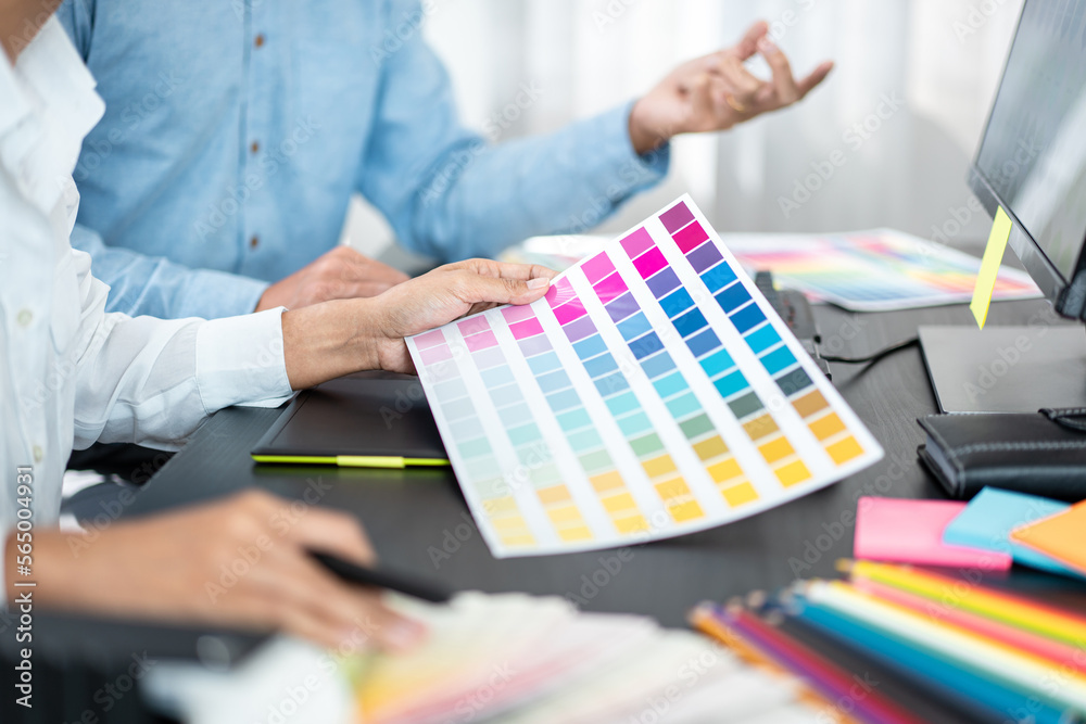 Poster two creative graphic designer team working on color selection and drawing on graphic tablet, color s