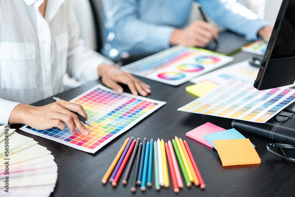 Aufkleber two creative graphic designer team working on color selection and drawing on graphic tablet, color s