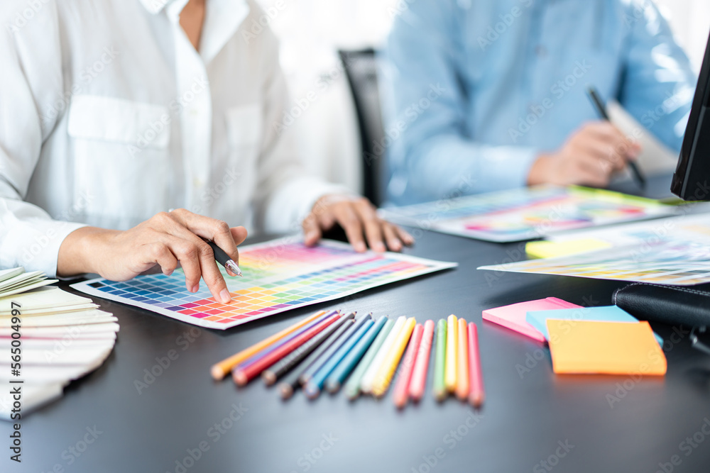 Poster two creative graphic designer team working on color selection and drawing on graphic tablet, color s