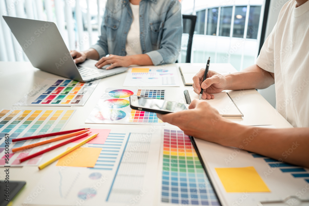 Poster two creative graphic designer team working on color selection and drawing on graphic tablet, color s