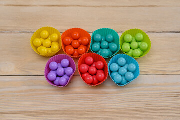 multicolored balls are laid out in a basket of the same color. a game for the development of children
