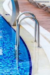 Close-up view of swimming pool with stairs