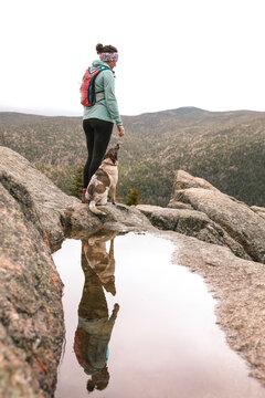 Woman hiking with dog, Mt Willard, New Hampshire, USA