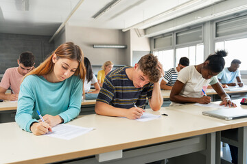 Multi ethnic teenager students taking exam at High School - Technical preparation course for University