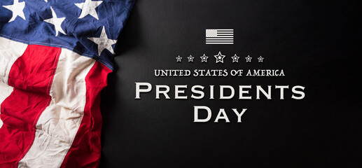 Happy presidents day concept with flag of the United States and the text on dark  background.