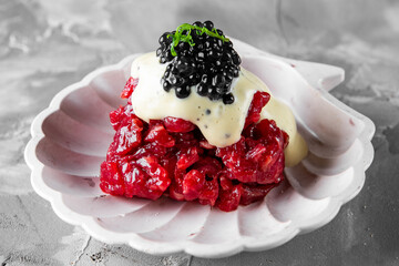 Raw beef meat tartar with sauce and caviar