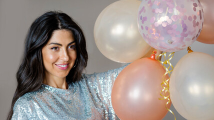 Beautiful smiling woman holding party balloons . Birthday concept