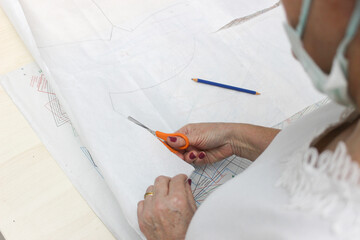 Tailor woman sewing beautiful dress