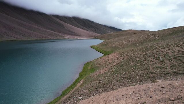 aerial of Chandra Taal Lake in the Himalaya Mountains of India on cloudy day with no tourists