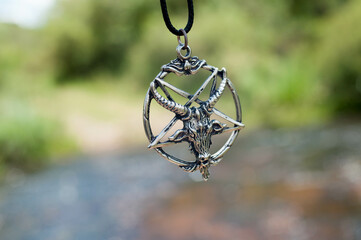 Closeup photograph of my pentagram with the river behind