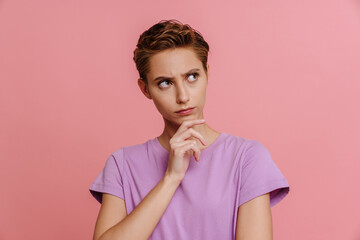 Portrait of young beautiful thoughtful woman touching her chin