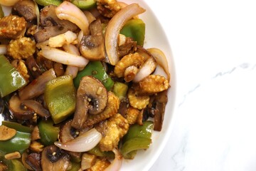 Fresh stir fried or sauteed vegetables. broccoli, zucchini, green and red peppers, mushrooms, onions, baby corn. colorful veggies in a white plate. Weightloss journey. Fitness concept. Healthy life.