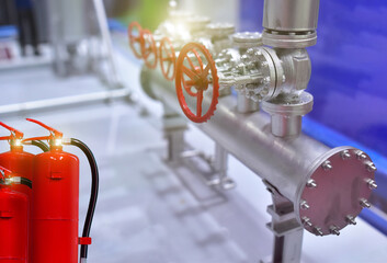 red fire extinguisher tank. control room for emergency safety located near the gas valve in factory.