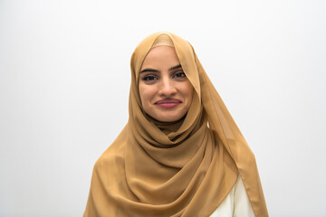 Portrait of young muslim woman wearing hijab on isolated white background