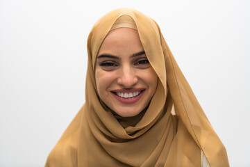 Portrait of young muslim woman wearing hijab on isolated white background