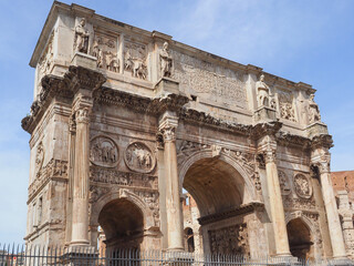 Fototapeta na wymiar Arch of Constantine or Arco di Costantino and part of Colosseum to right. High Roman structure, triumphal arch, victory over Maxentius at Battle of Milvian Bridge, made up of three decorated arches.