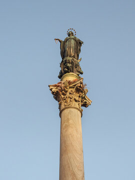 Marian monument, cipollino marble column with bronze statue of Blessed Virgin Mary on the top, known as Column of the Immaculate Conception or Colonna dell'Immacolata. Piazza Mignanelli square, Rome.