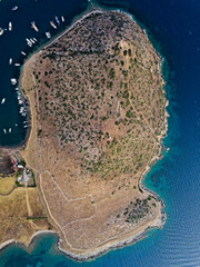 Bird's-eye view of the island in Bodrum Sea and the boats around it with a drone