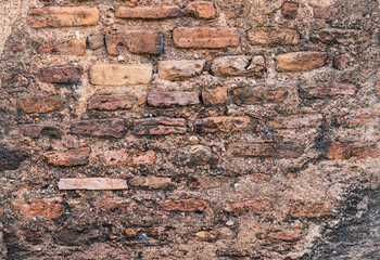Grunge textured old abandoned brick wall with distressed plaster