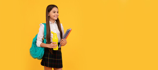 happy kid with backpack and workbooks going to drink water bottle in uniform full length, schoolgirl. Banner of school girl student. Schoolgirl pupil portrait with copy space.