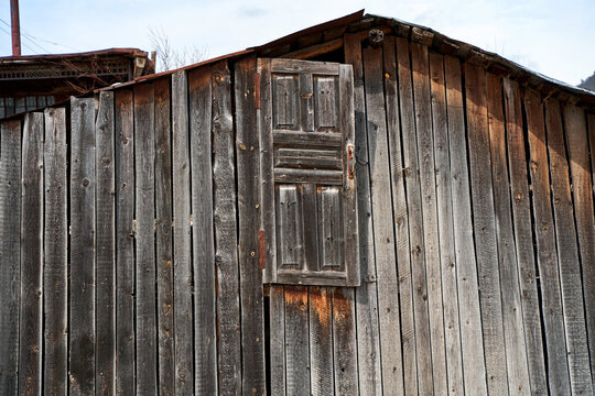 The exterior of the old rural architecture of wood in the village. Barn made of wood