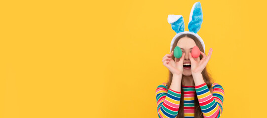surprised bunny kid. happy easter holiday. funny child hold painted eggs. teenager girl rabbit. Easter child horizontal poster. Web banner header of bunny kid, copy space.