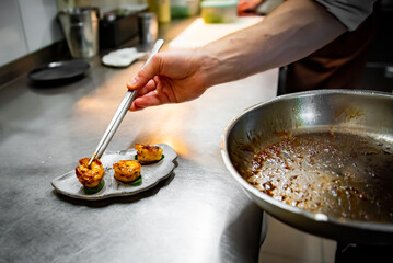 man chef cooking fried shrimp on kitchen