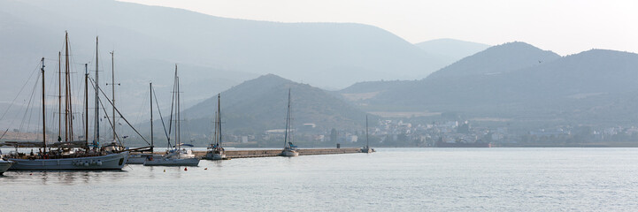 Fototapeta na wymiar Panoramic shot of Sailing Boats in the harbour of Volos, at sunrise
