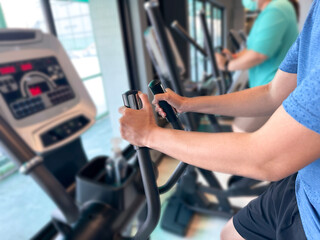 Close up of hand holding a electric bike exercise machine in fitness. Concept for healthy and lose weight.